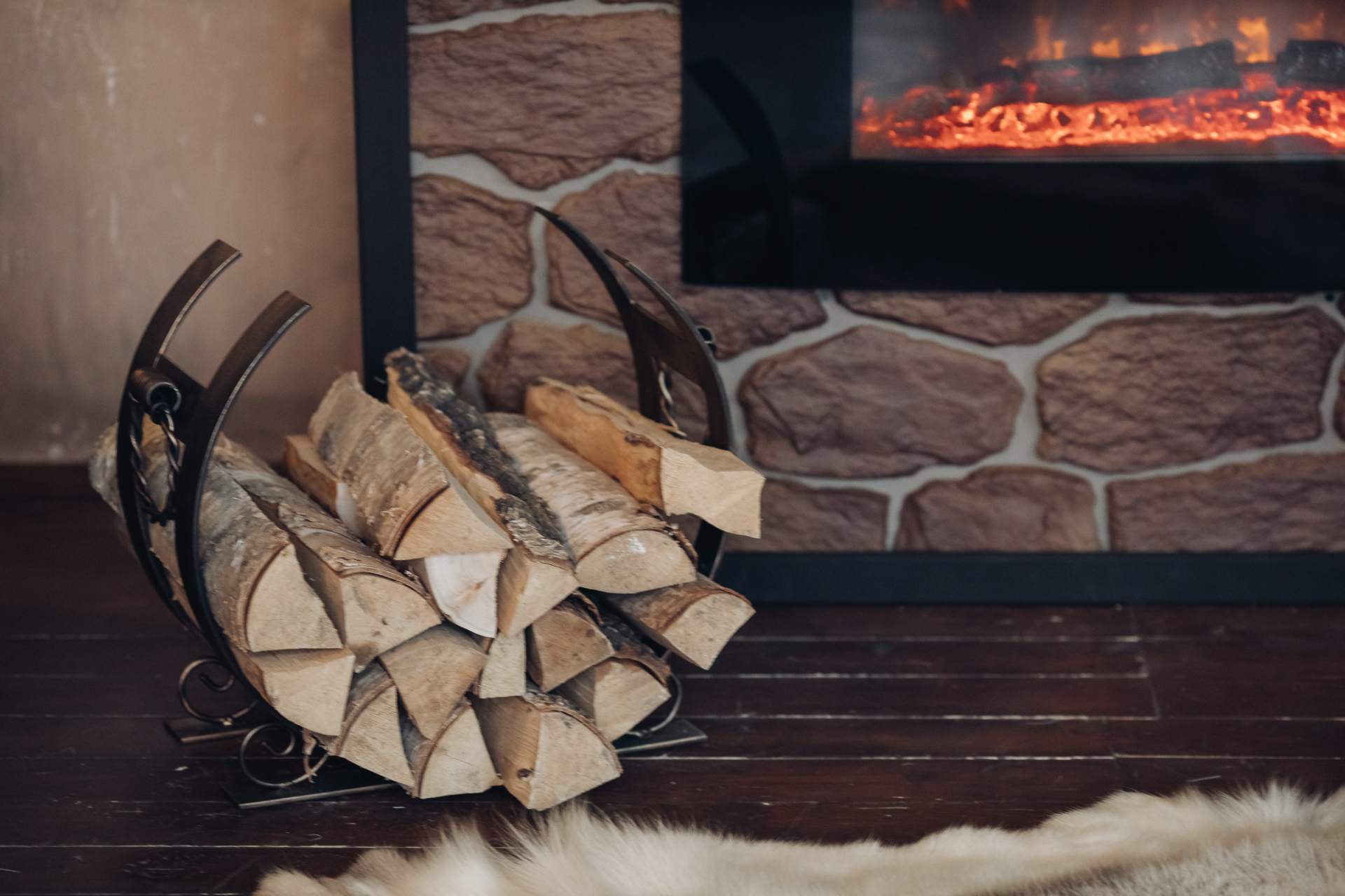 decorative-metallic-holder-with-heap-wooden-logs-stony-fireplace-with-burning-logs (2) (1)